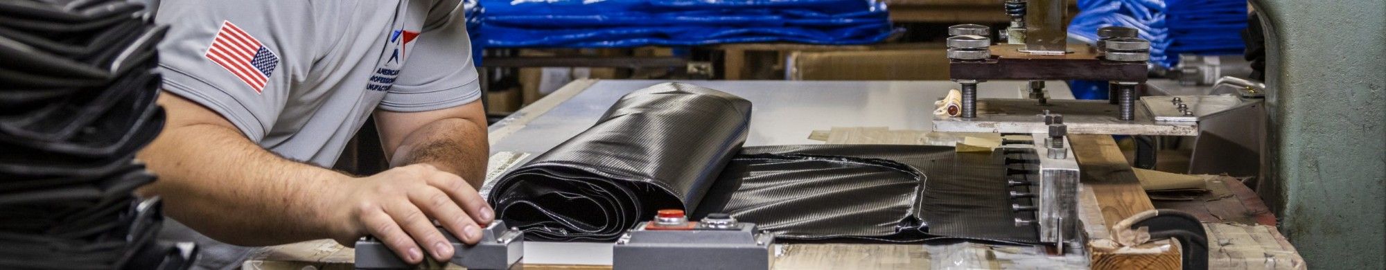 An APM operator heat-sealing the seam of a black heavy-duty body bag on the RF welding press